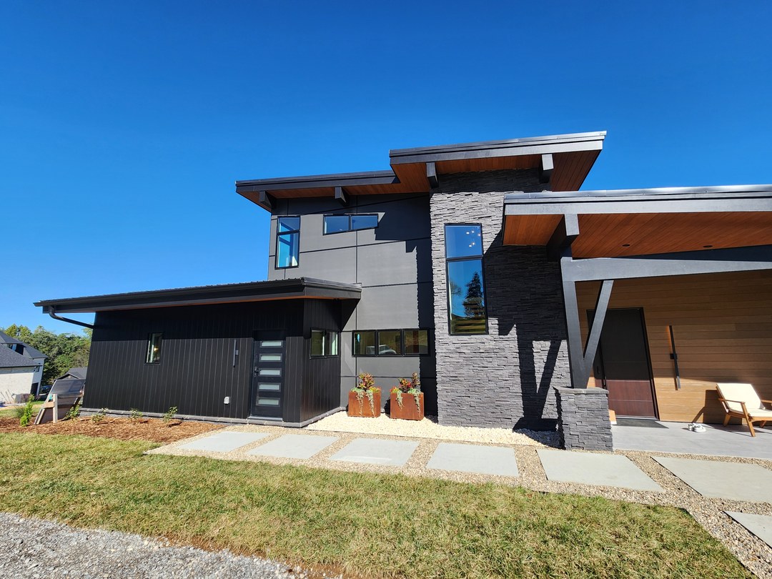 Modern exterior with deep overhangs and stone