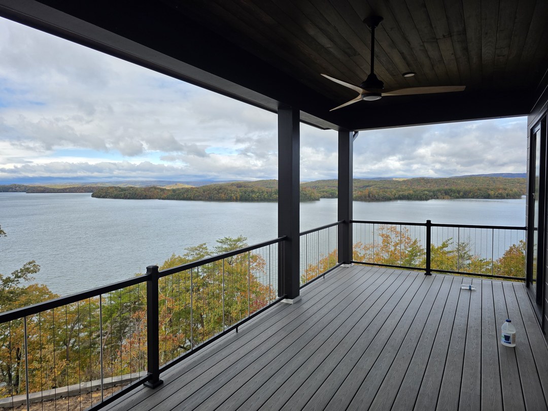 Covered deck with a cedar ceiling overlooking the water