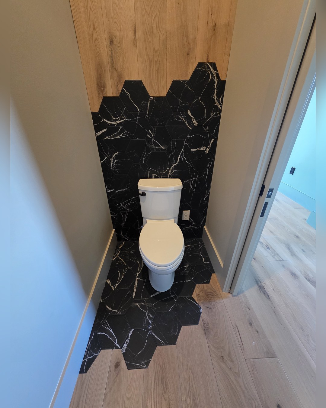 Bathroom with black marble and a patterned tile floor