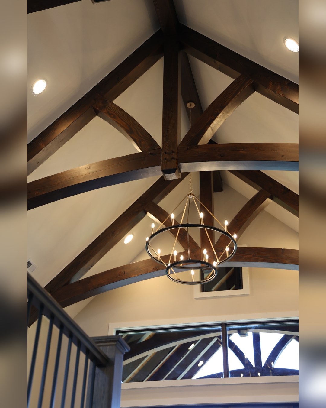 Timber trusses and a chandelier at the ridge