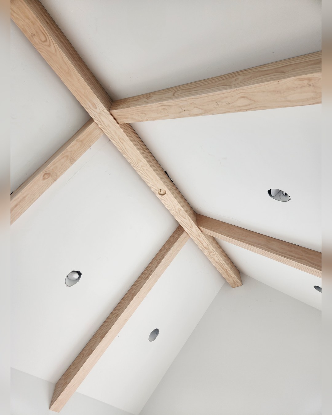 Timber detail against a white vaulted ceiling